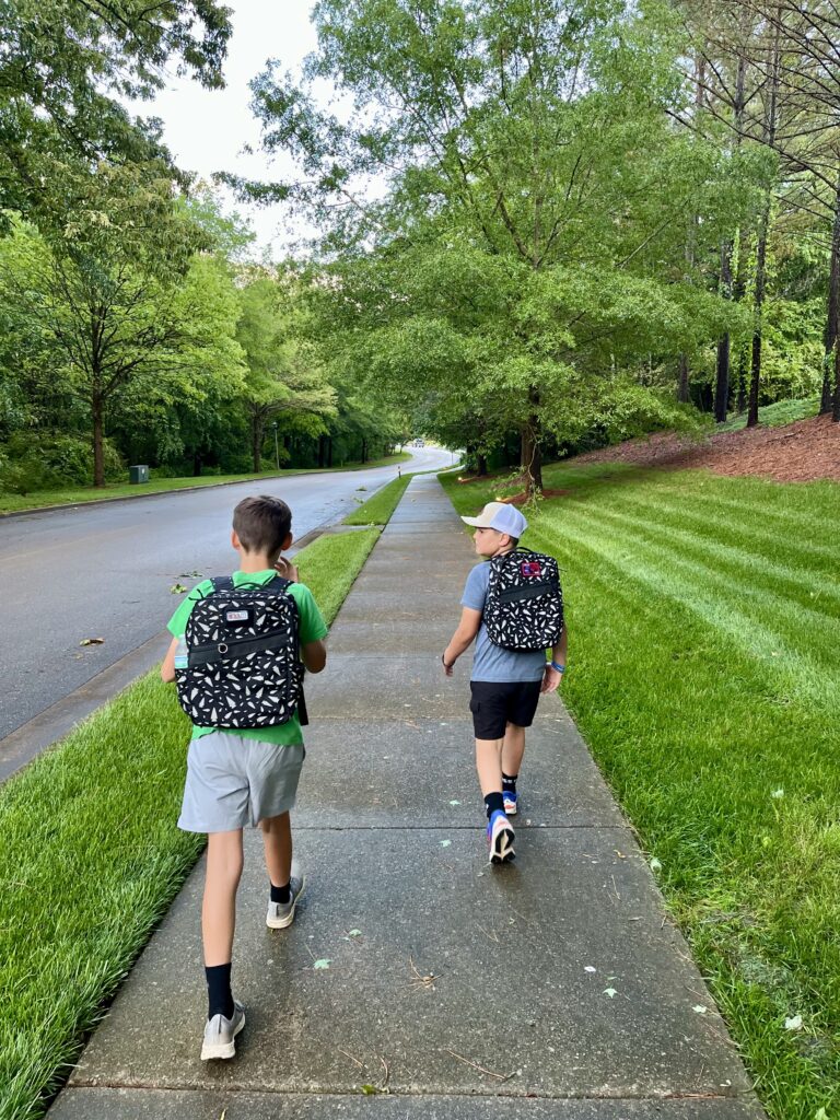kids rucking with weighted backpacks for fitness and community, wearing GORUCK KR1